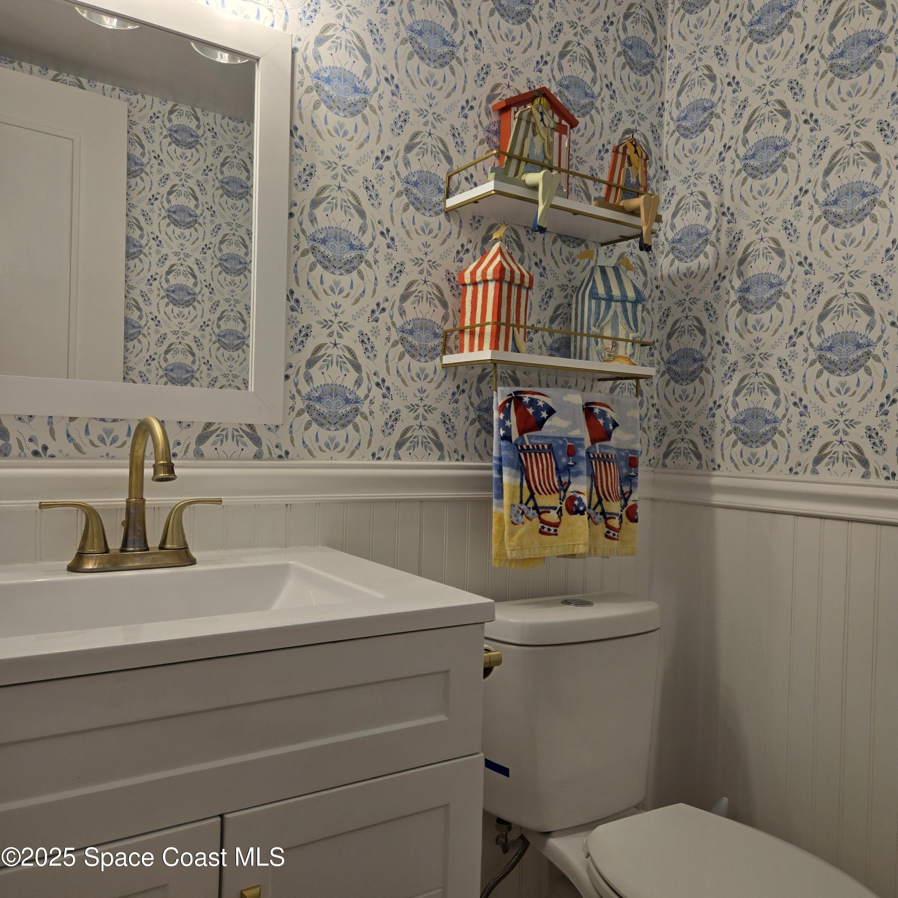 8761 Ilex Court Cape Canaveral, FL 32920 - Photo 7 of 41 a bathroom with a sink and a toilet