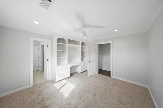 an empty room with windows and cabinet