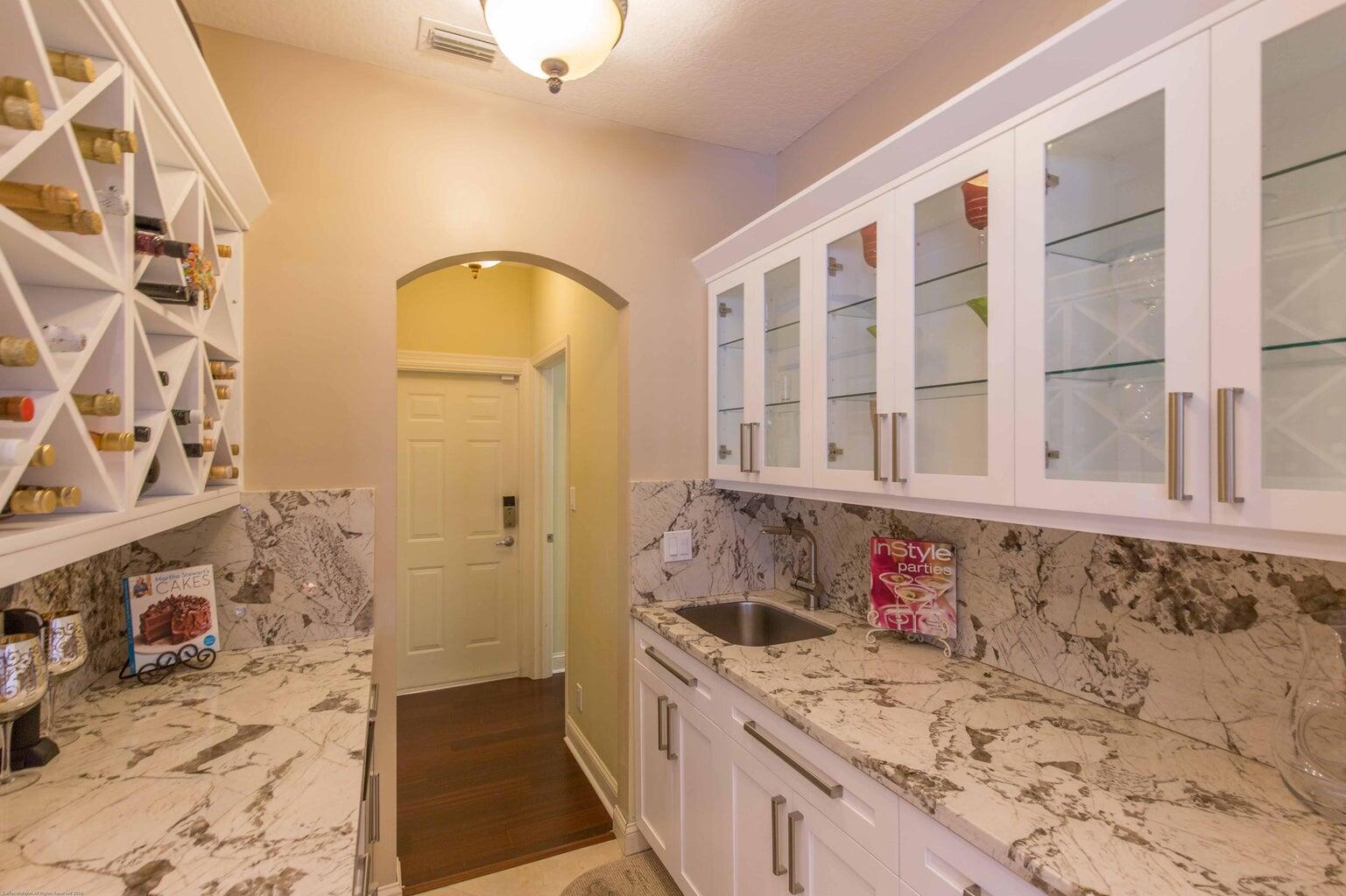 14816 Stirrup Lane Wellington, FL 33414 - Photo 11 of 30 a bathroom with a granite countertop tub sink and mirror