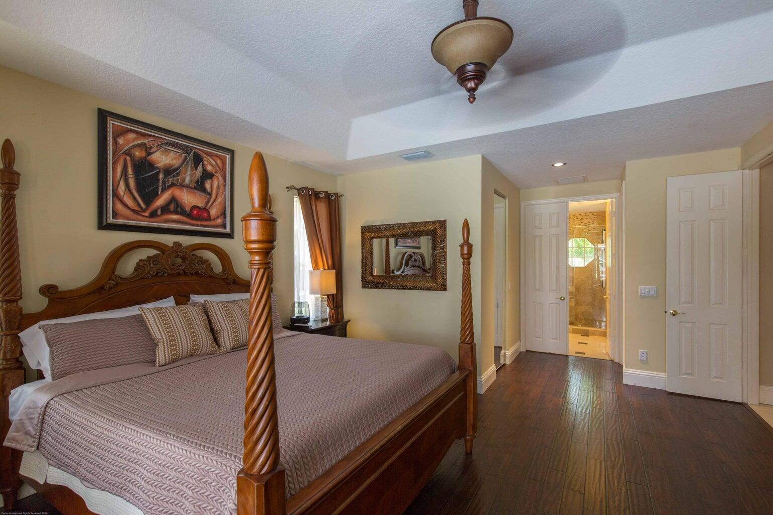 14816 Stirrup Lane Wellington, FL 33414 - Photo 14 of 30 a bedroom with a bed and cabinets