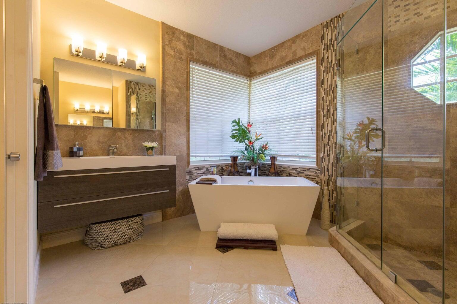 14816 Stirrup Lane Wellington, FL 33414 - Photo 16 of 30 a bathroom with a tub and shower