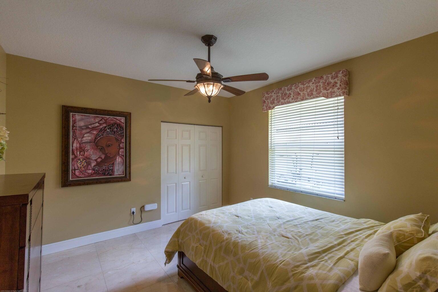 14816 Stirrup Lane Wellington, FL 33414 - Photo 18 of 30 a bedroom with a bed and a window