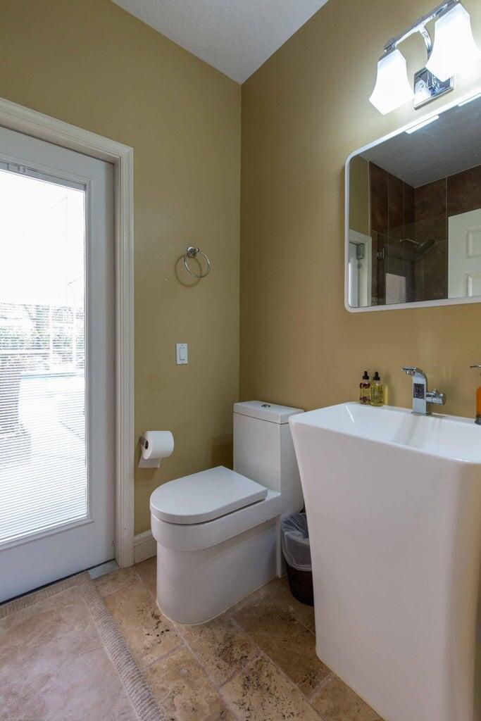 14816 Stirrup Lane Wellington, FL 33414 - Photo 22 of 30 a bathroom with a toilet sink and mirror