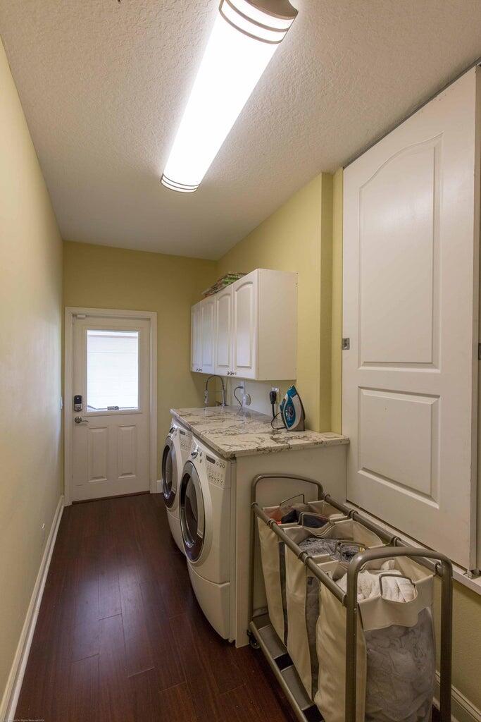 14816 Stirrup Lane Wellington, FL 33414 - Photo 23 of 30 a kitchen with a stove top oven sink and cabinets