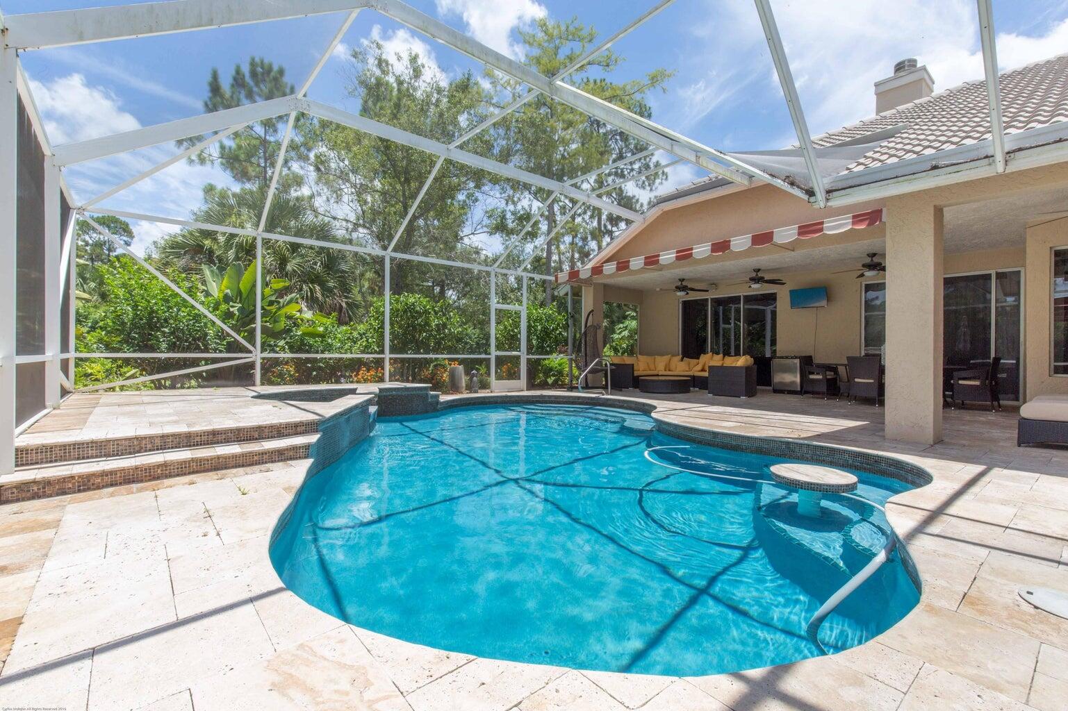 14816 Stirrup Lane Wellington, FL 33414 - Photo 26 of 30 a view of a swimming pool with a patio