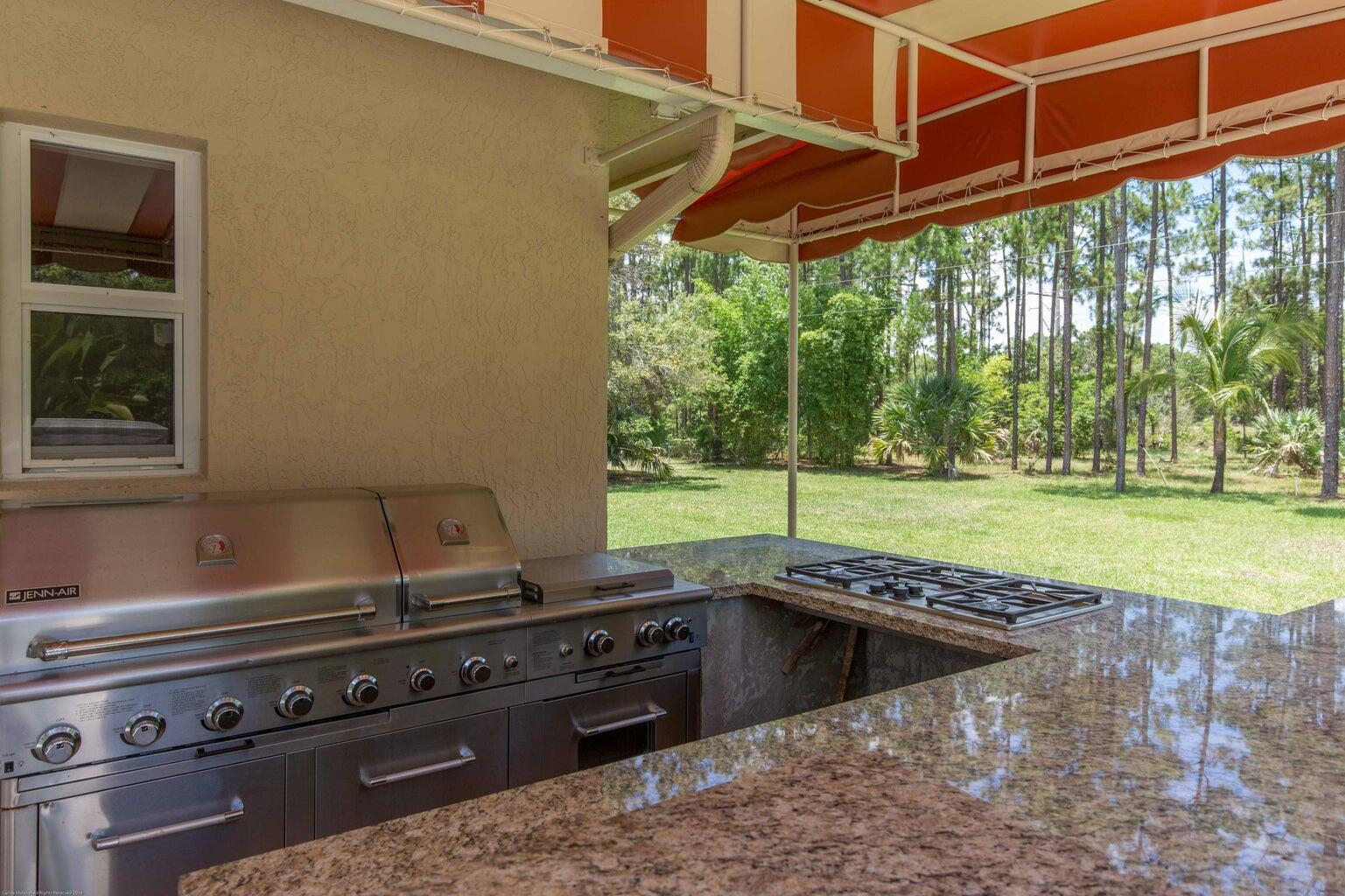 14816 Stirrup Lane Wellington, FL 33414 - Photo 27 of 30 a view of a backyard of a house