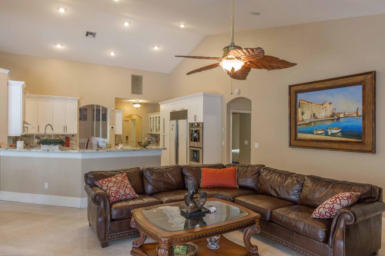 14816 Stirrup Lane Wellington, FL 33414 - Photo 5 of 30 a living room with furniture a lamp and a chandelier