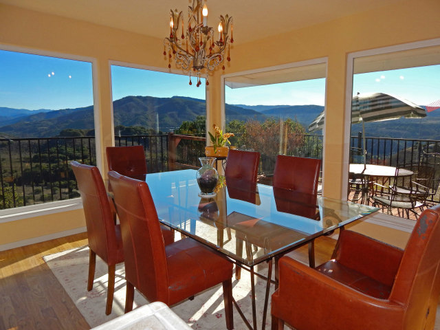 a view of a dining room with furniture window and outside view