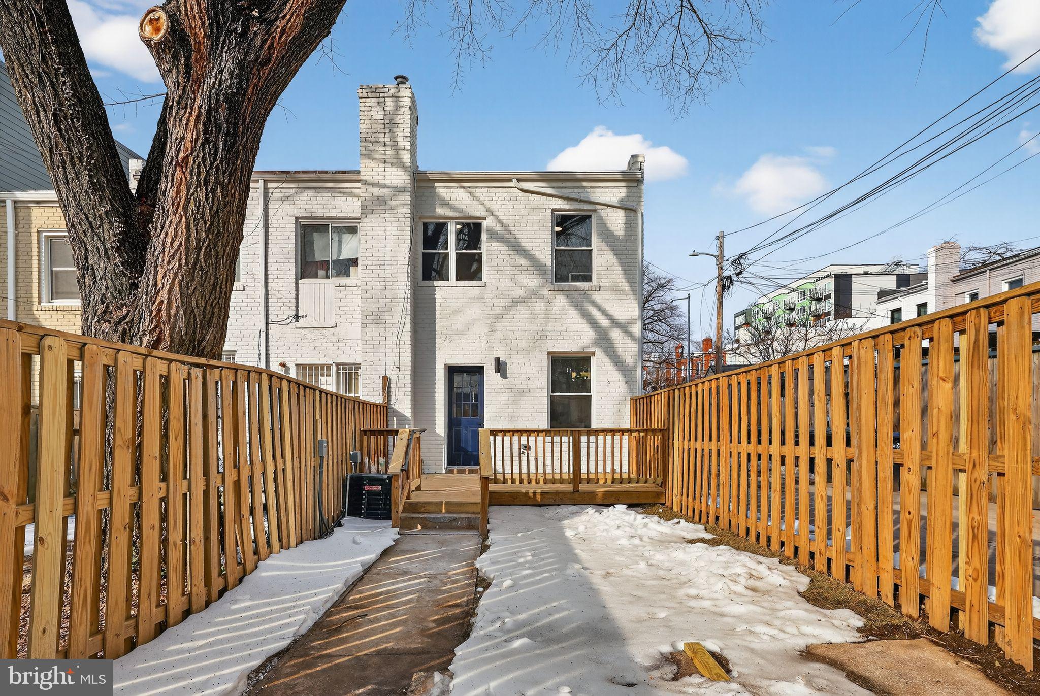 777 18th Street Northeast Washington, DC 20002 - Photo 19 of 22 a view of a brick house with wooden fence and large trees