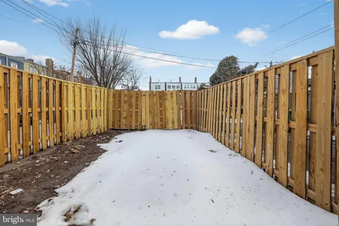 a view of a pathway with a wooden fence