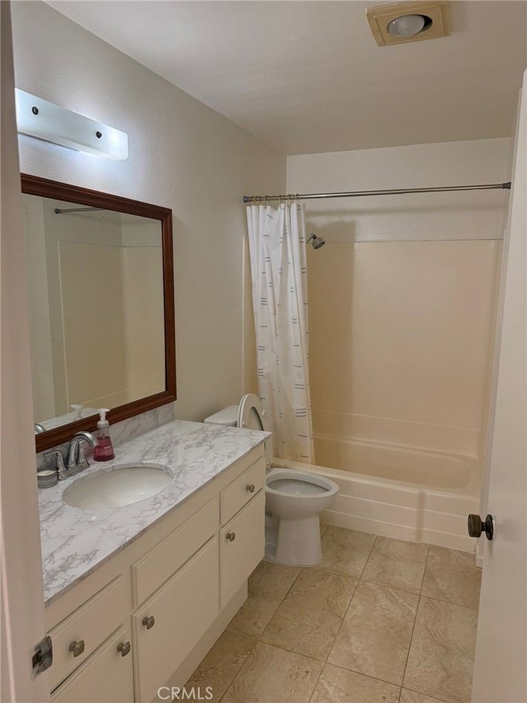 25 Orange Blossom, Unit 61 Irvine, CA 92618 - Photo 12 of 12 a bathroom with a granite countertop sink toilet and shower