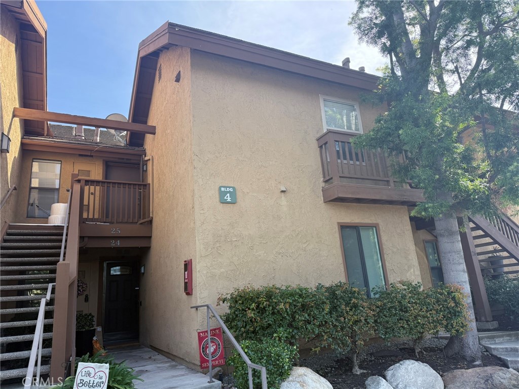 25 Orange Blossom, Unit 61 Irvine, CA 92618 - Photo 2 of 12 a front view of a house with garden
