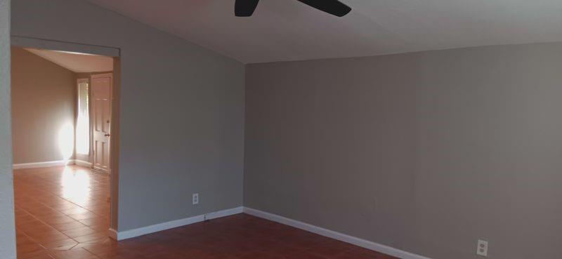 4135 B Hawthorne Avenue, Unit B Dallas, TX 75219 - Photo 4 of 7 Spare room with lofted ceiling, ceiling fan, and dark tile patterned floors
