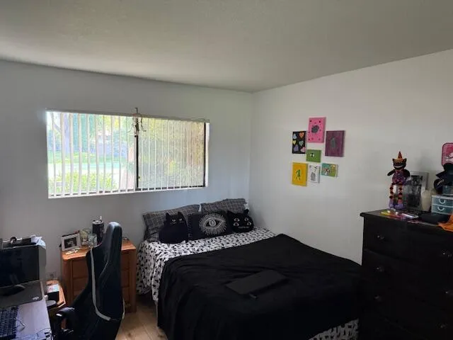 a bedroom with a bed and window