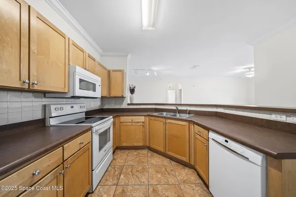 a kitchen with a sink cabinets and window
