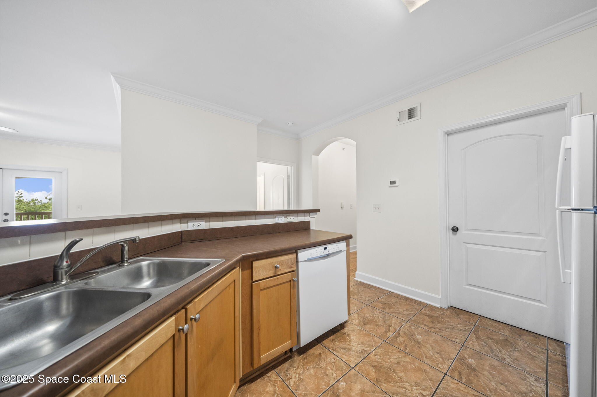 6421 Borasco Drive, Unit 3206 Melbourne, FL 32940 - Photo 17 of 36 a kitchen with a sink and cabinets