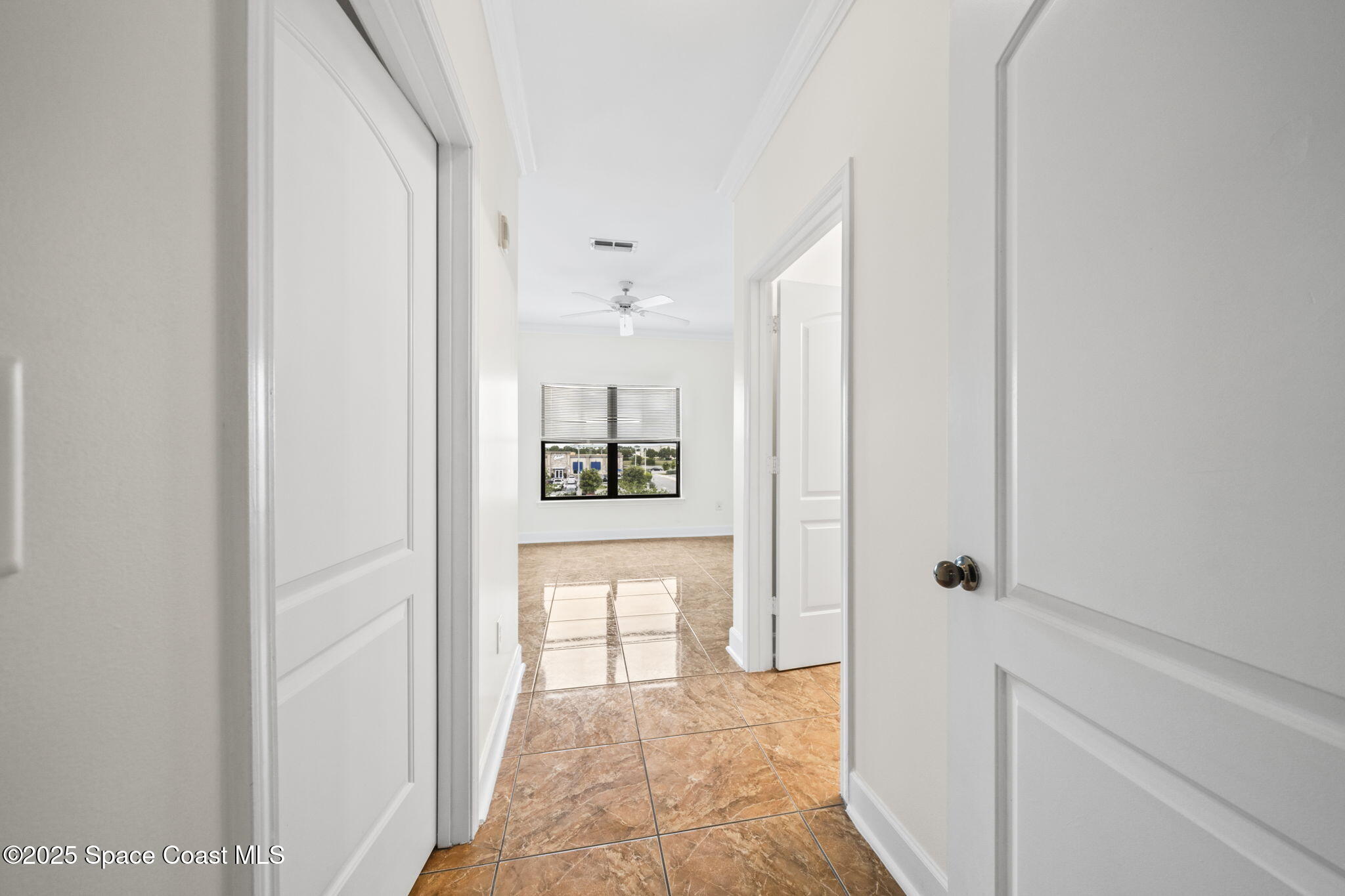 6421 Borasco Drive, Unit 3206 Melbourne, FL 32940 - Photo 21 of 36 a view of a hallway with wooden floor and a bathroom