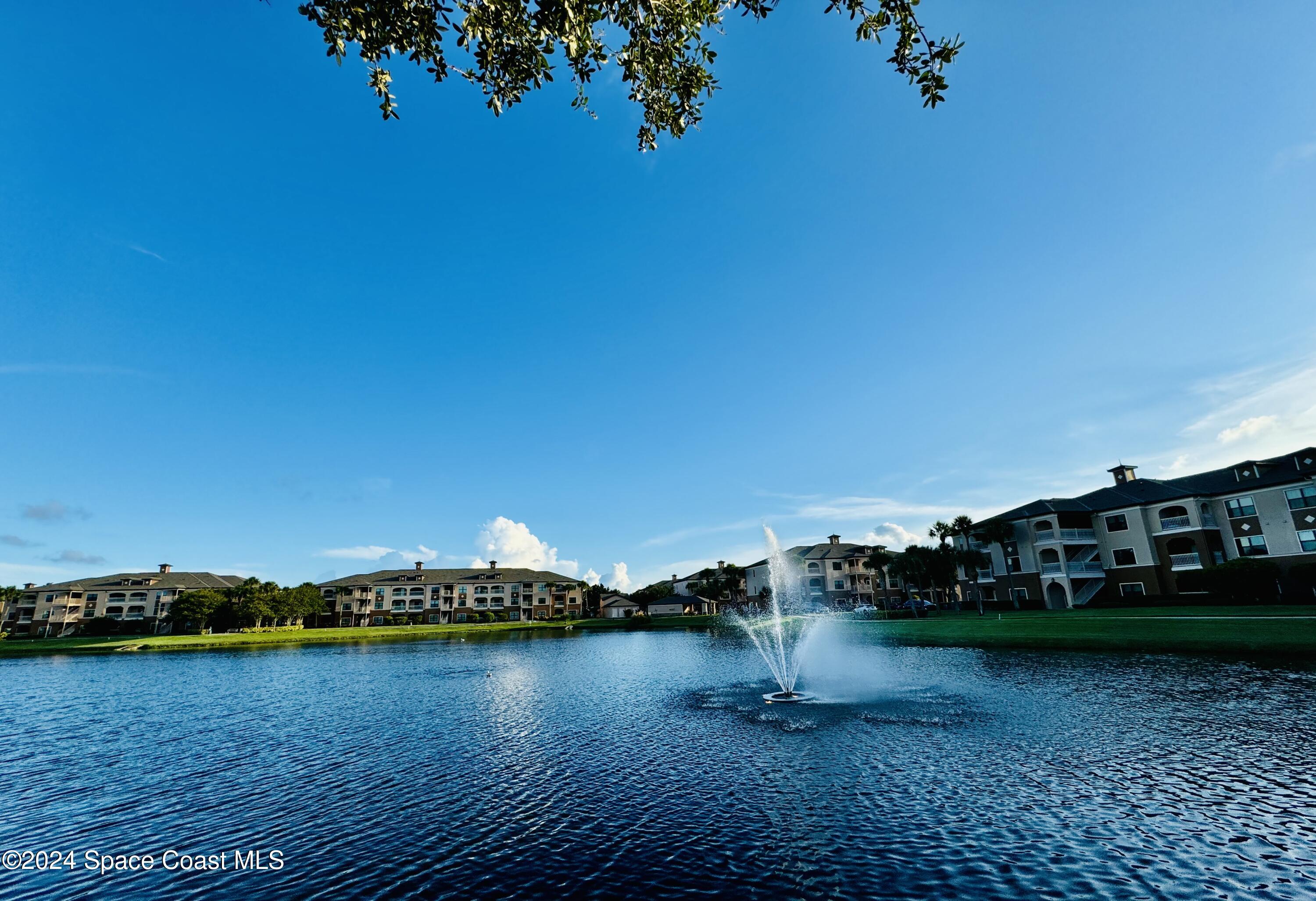 6421 Borasco Drive, Unit 3206 Melbourne, FL 32940 - Photo 7 of 36 a view of a lake with houses