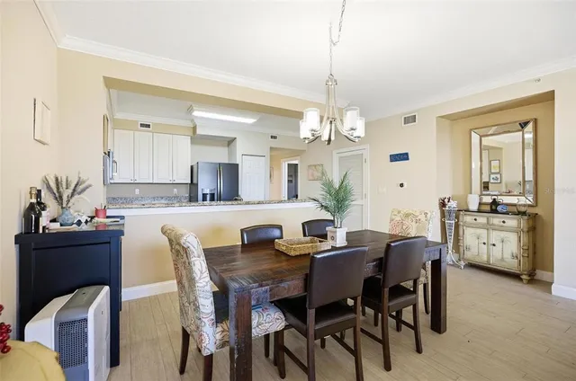 a view of a dining room with furniture and chandelier
