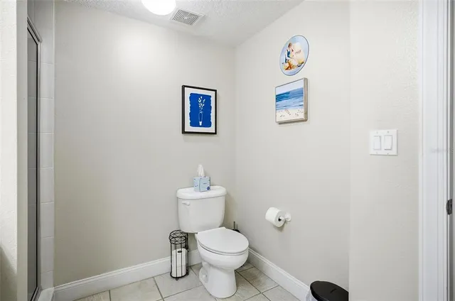 a white toilet sitting next to a white walls