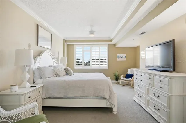 a bedroom with a bed and a flat screen tv in it