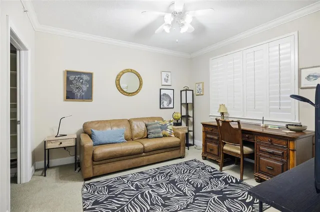 a living room with furniture a chandelier and a window