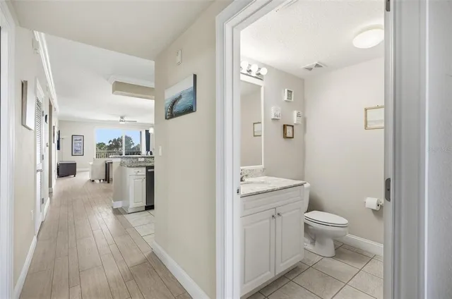 a view of bathroom with a toilet sink and mirror