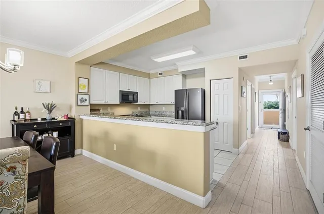 a kitchen with stainless steel appliances granite countertop a refrigerator stove microwave and sink