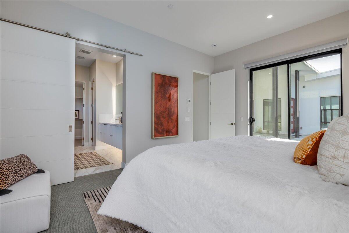 151 Holliday Way Palm Springs, CA 92262 - Photo 21 of 40 a bedroom with a bed and wooden floor