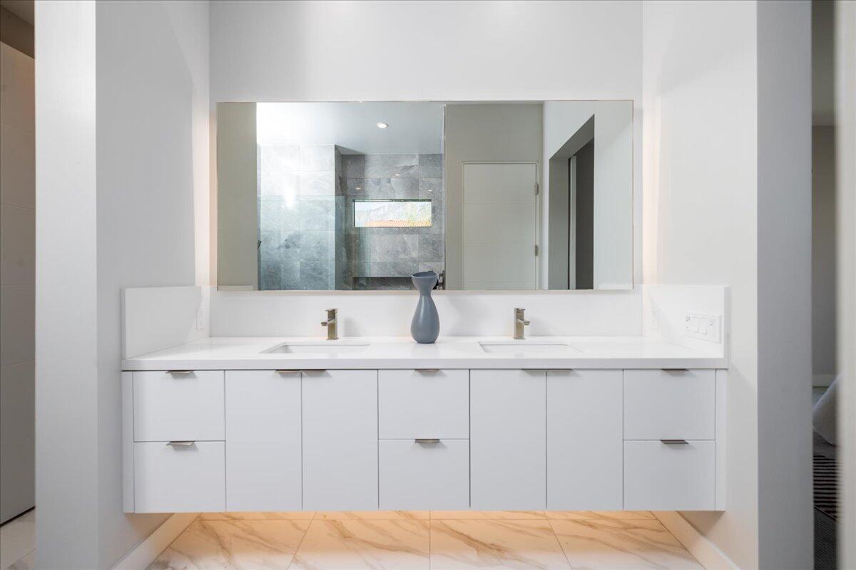 151 Holliday Way Palm Springs, CA 92262 - Photo 22 of 40 a bathroom with a sink and a mirror