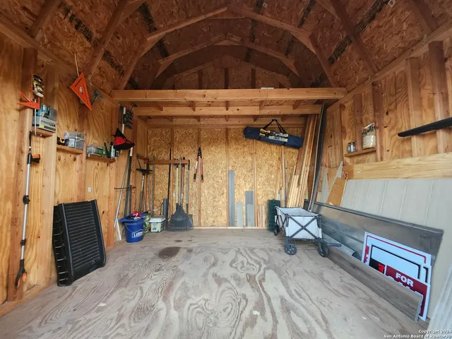 a view of a room with wooden floor and windows