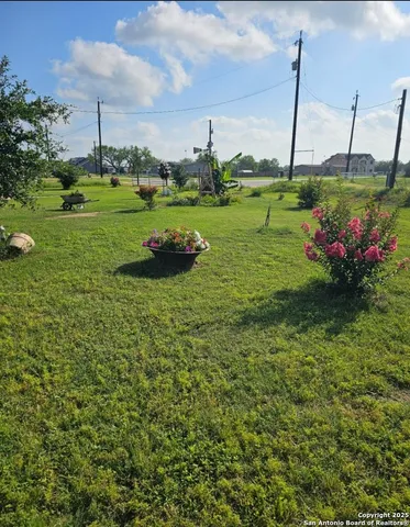 a view of a garden with a building in the background