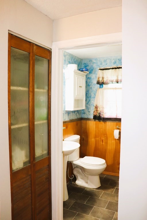 231 Rosewell Street Springfield, MA 01109 - Photo 11 of 24 a bathroom with a granite countertop toilet and a shower