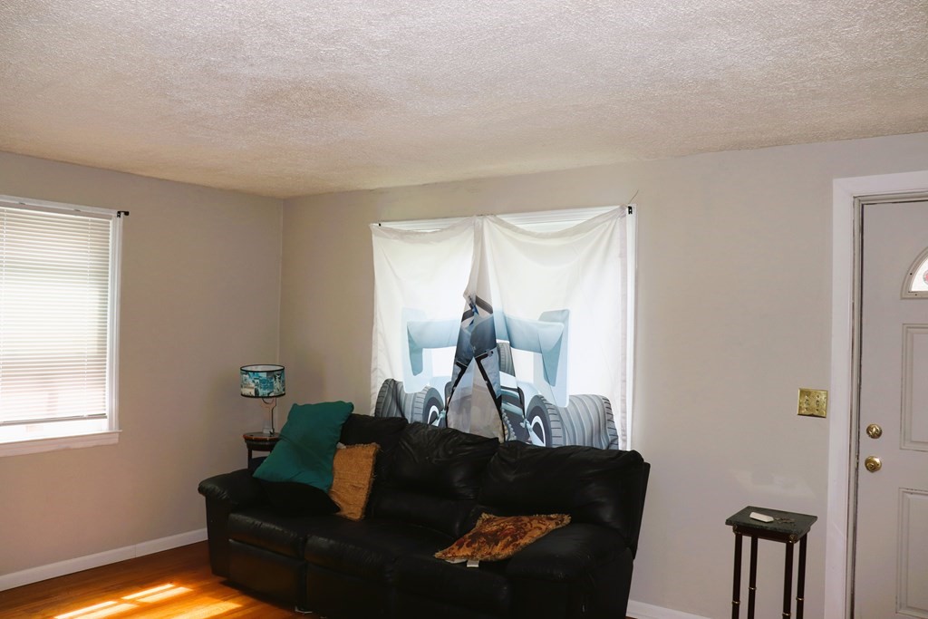 231 Rosewell Street Springfield, MA 01109 - Photo 12 of 24 a living room with furniture and a window
