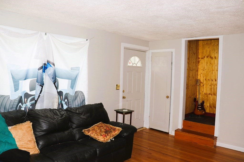 231 Rosewell Street Springfield, MA 01109 - Photo 13 of 24 a living room with furniture and a wooden floor