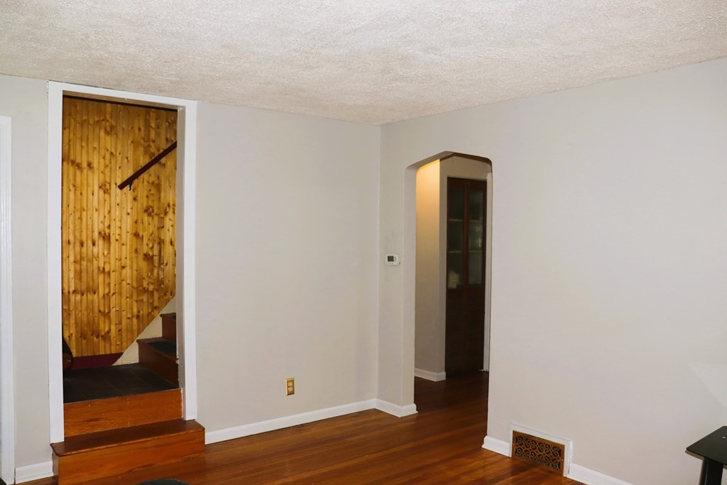 231 Rosewell Street Springfield, MA 01109 - Photo 14 of 24 a view of a hallway with wooden floor and a bathroom