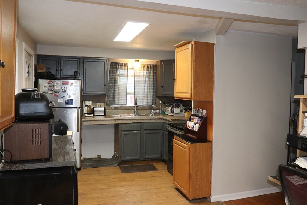 231 Rosewell Street Springfield, MA 01109 - Photo 6 of 24 a kitchen with stainless steel appliances granite countertop a stove and a refrigerator