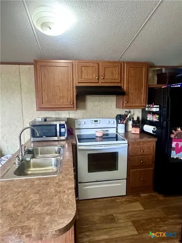 a kitchen with a stove and a sink