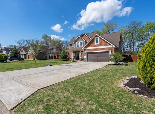 a front view of a house with a yard and garage
