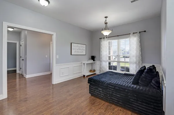 a living room with furniture and a wooden floor