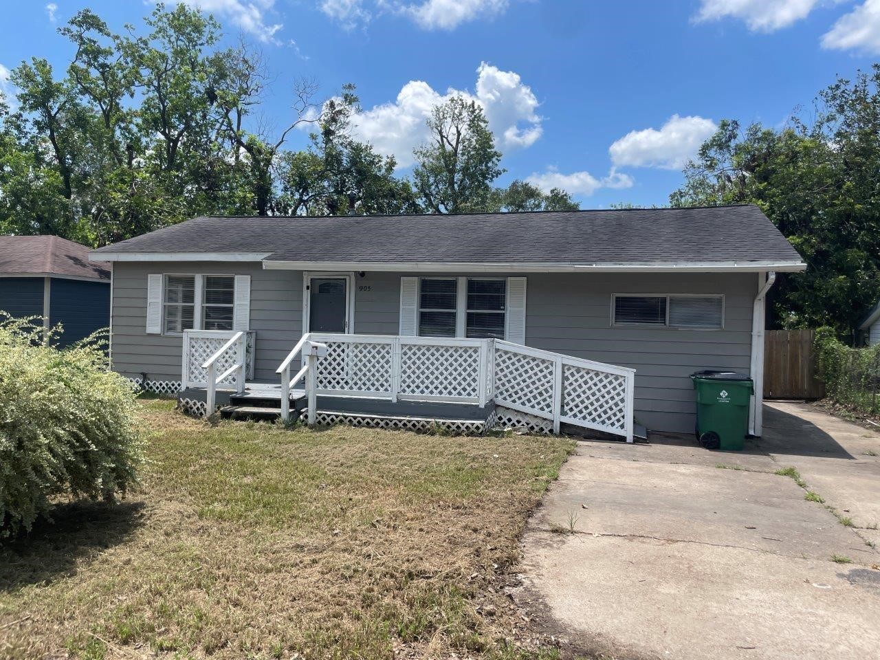 a view of a house with a patio and a yard