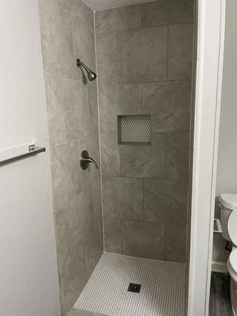 905 North Arcola Street Angleton, TX 77515 - Photo 11 of 17 a bathroom with a shower and toilet