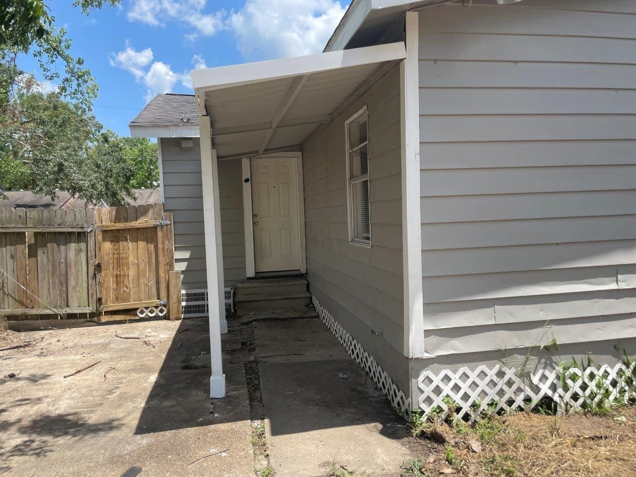 905 North Arcola Street Angleton, TX 77515 - Photo 15 of 17 a view of a house with a door and wooden walls