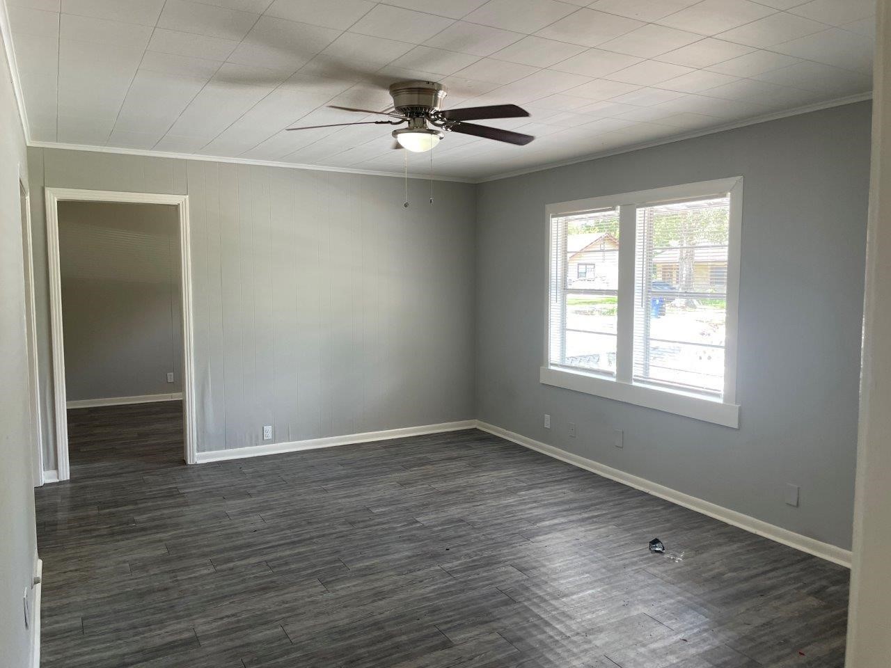 905 North Arcola Street Angleton, TX 77515 - Photo 4 of 17 a view of an empty room with wooden floor and a window