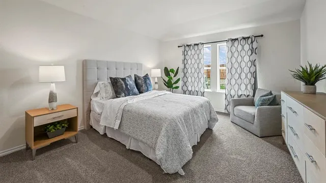 a bedroom with a bed and a couch