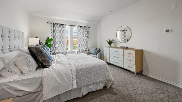 a bedroom with a large bed and a dresser