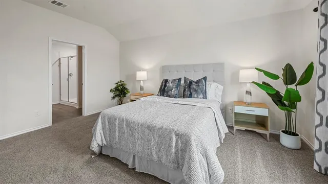 a bedroom with a bed and a potted plant