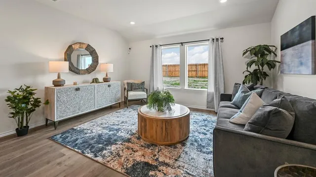 a living room with furniture and a potted plant