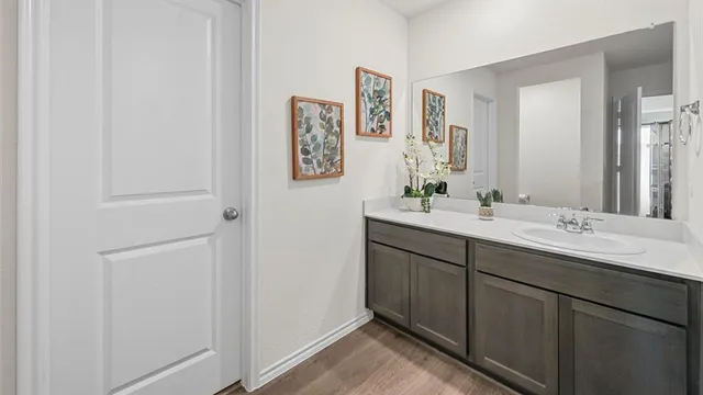 a bathroom with a double vanity sink and a mirror