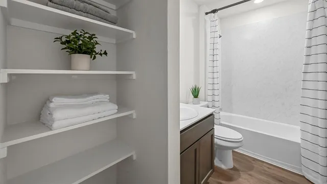 a bathroom with a toilet a sink and bathtub